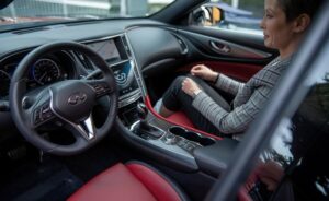 Woman in passenger seat of infiniti-Certified Infiniti collision repair Dingmans