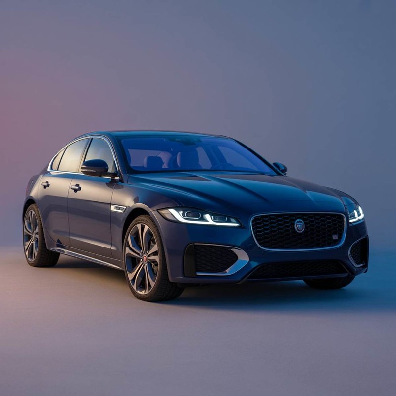 dark-blue-jaguar-showroom-Dingmans-Collision-Center silver-2025-Cadillac-CTV-showroom-setting-GM-Certified-Collision-Repair